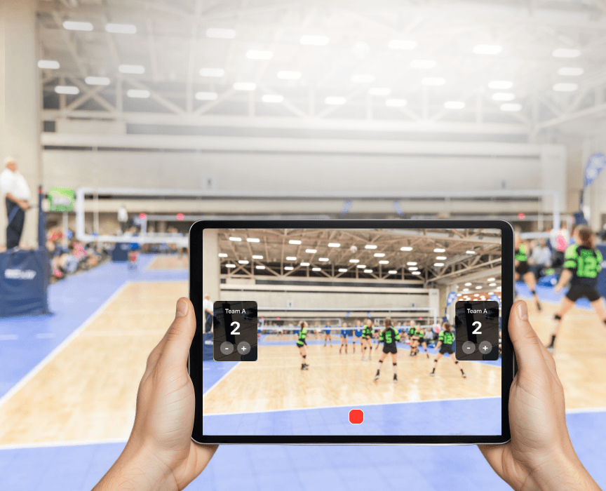 Volleyball score overlay with team names and set score shown on a Varsity Score video